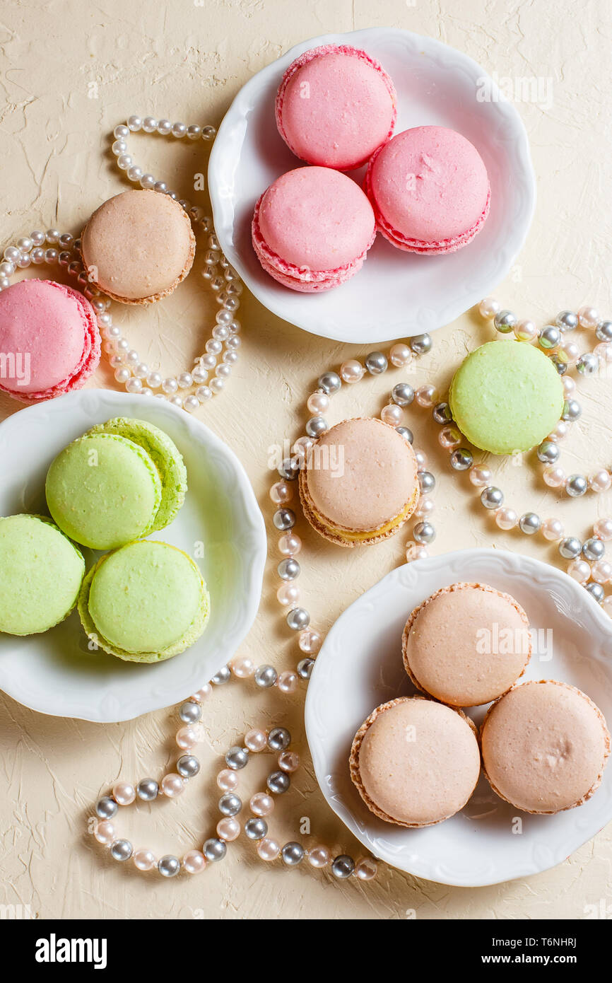 Colourful macaroons on the plates Stock Photo