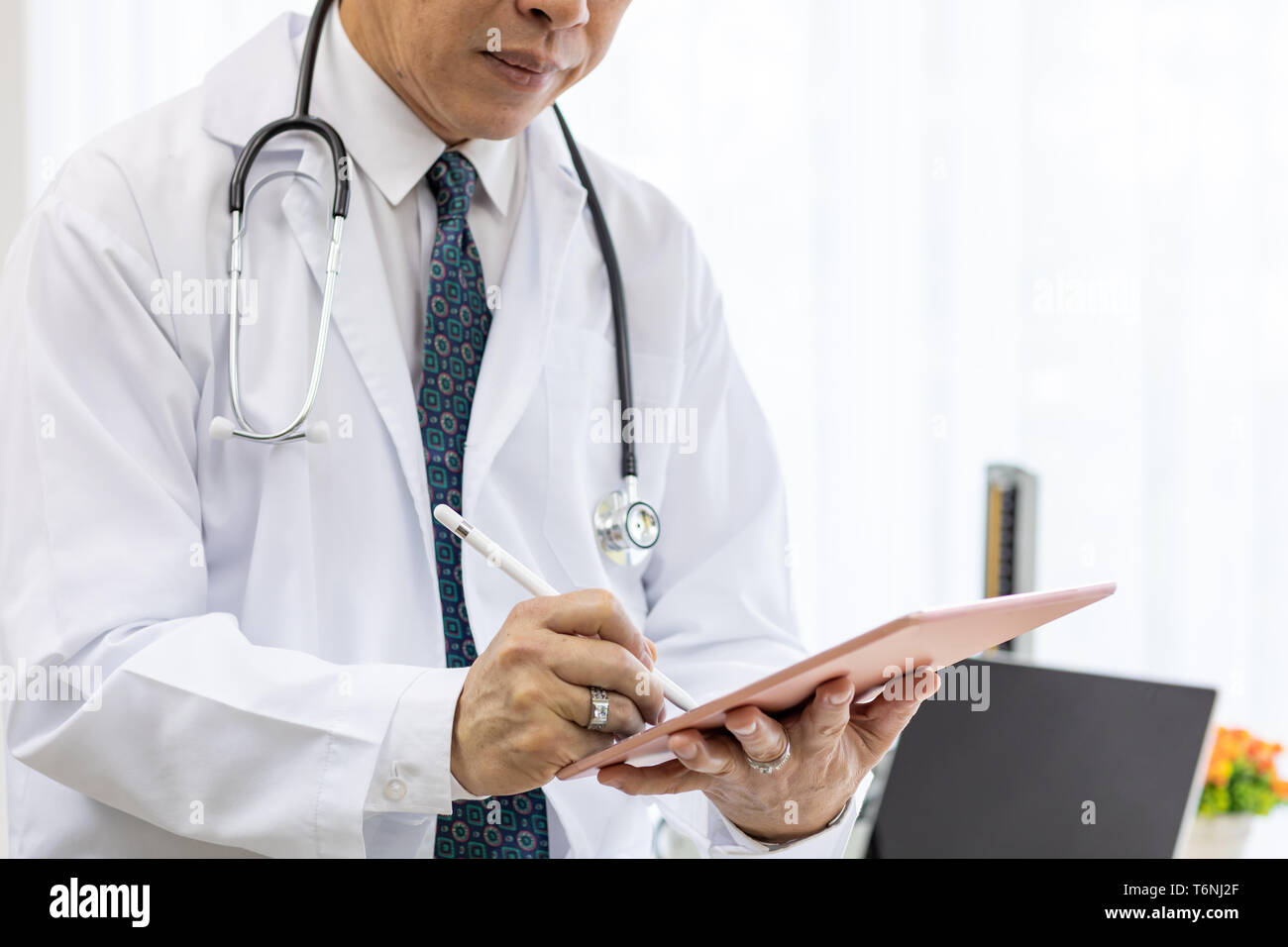 senior Doctor using tablet Stock Photo