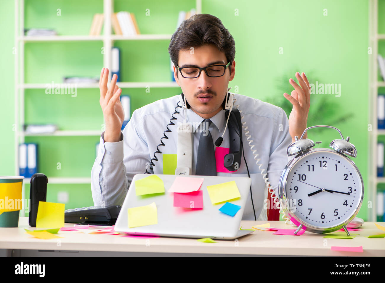 Young Help Desk Operator Working In Office With Many Conflicting