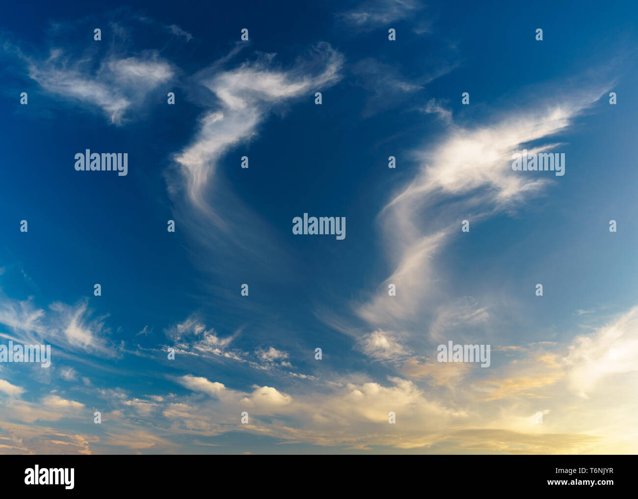 Scenic and warm cloudscape golden hour panorama, natural background Stock Photo