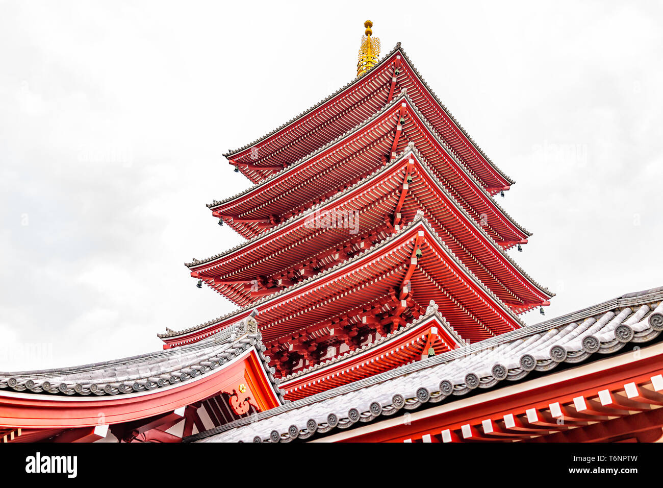 Tokyo, Japan Asakusa with low angle pagoda roof view of Sensoji temple shrine with red architecture on cloudy day Stock Photo