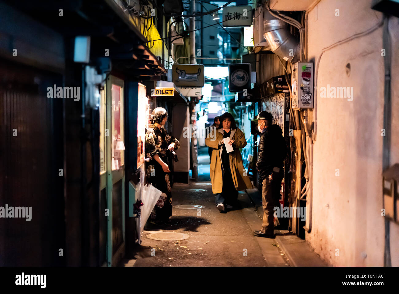 Shinjuku, Japan - April 3, 2019: Famous Golden Gai alley street in downtown city with night with people walking Stock Photo