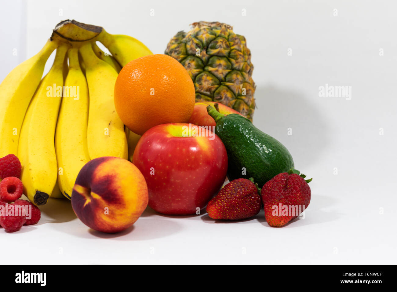 Arranged assortment of fresh, organic fruits. Vegan and clean eating lifestyles, promoting health and wellbeing, Vitamins and weight loss Stock Photo
