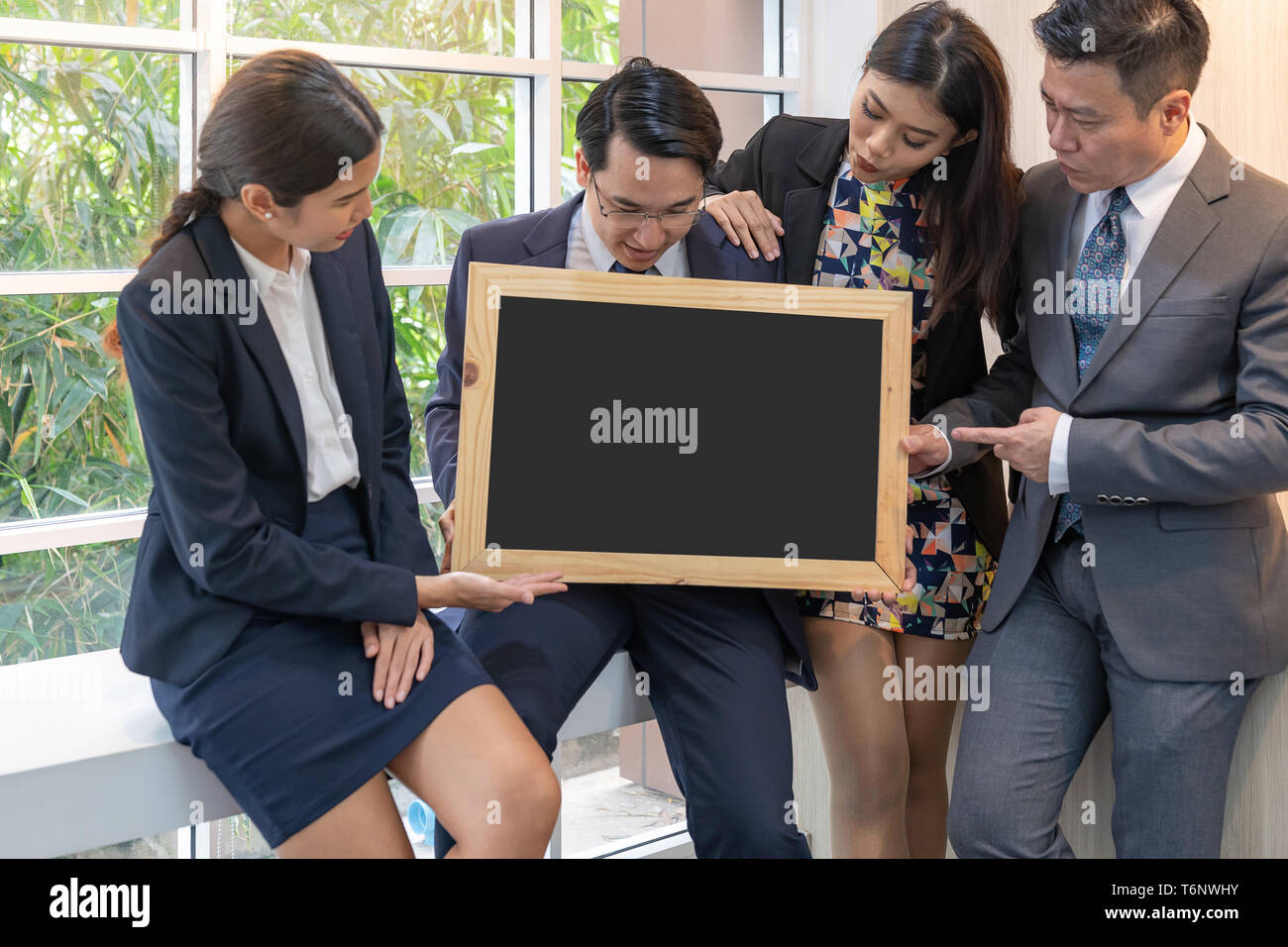 business people hold blank blackboard Stock Photo