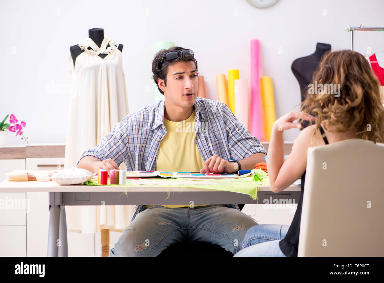 Young tailor working in his workshop Stock Photo - Alamy