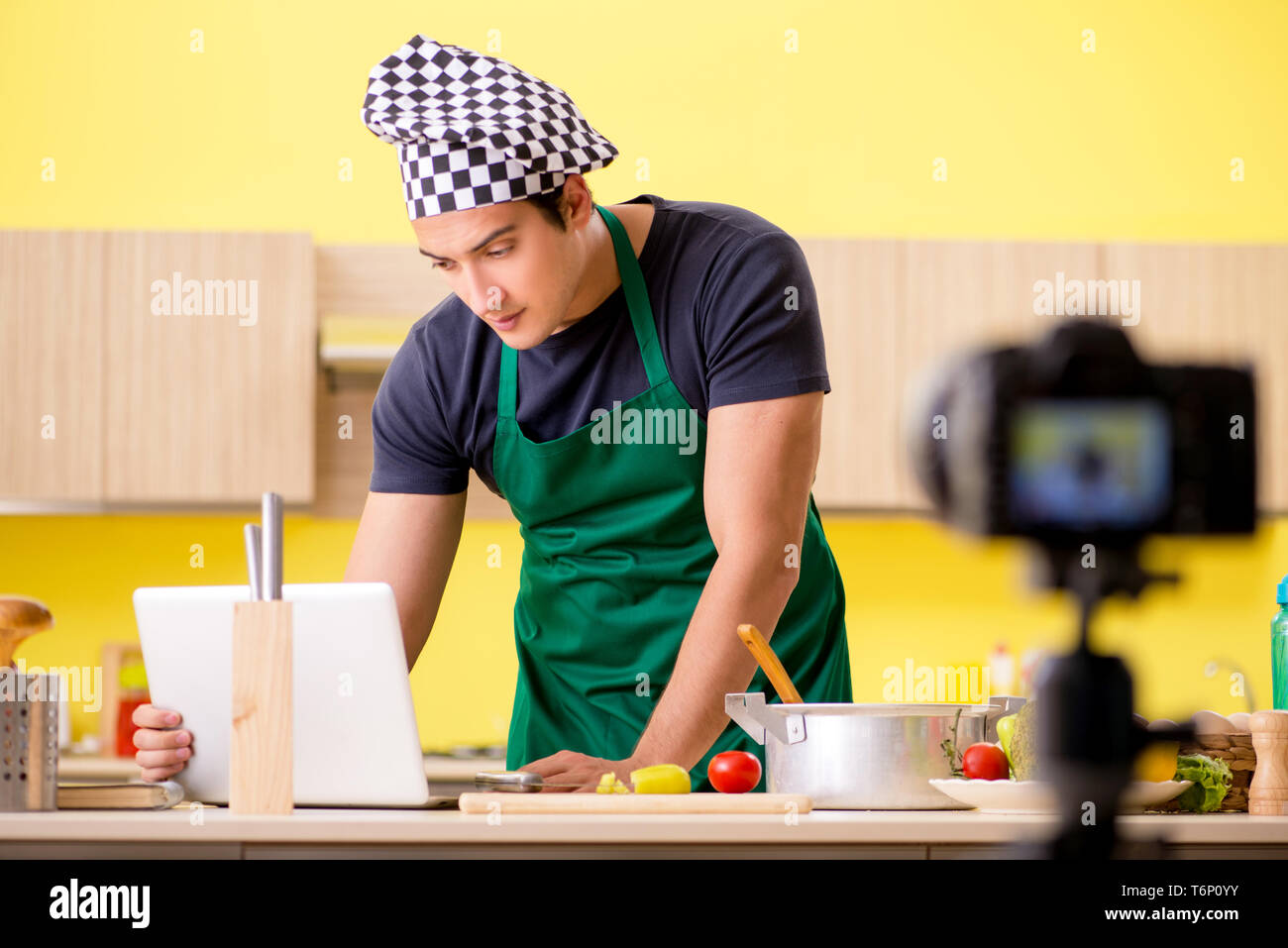 Young chef blogger explaining food preparation Stock Photo