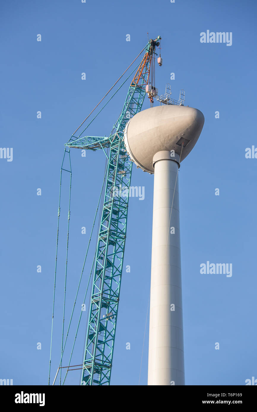 Construction site wind turbine with hoisting of rotor house Stock Photo ...