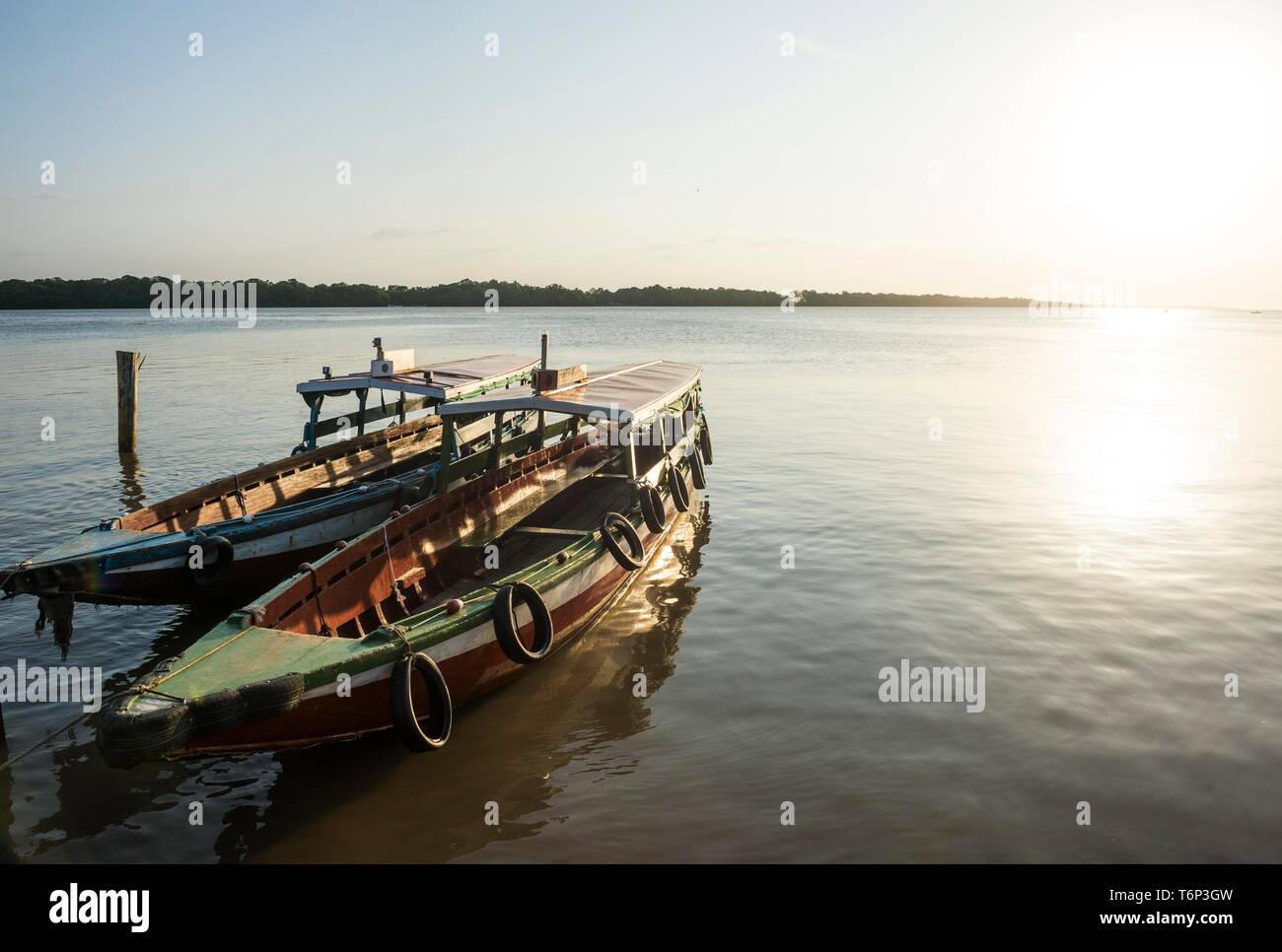 Boats at sunset on the Suriname river near Paramaribo, Suriname Stock Photo
