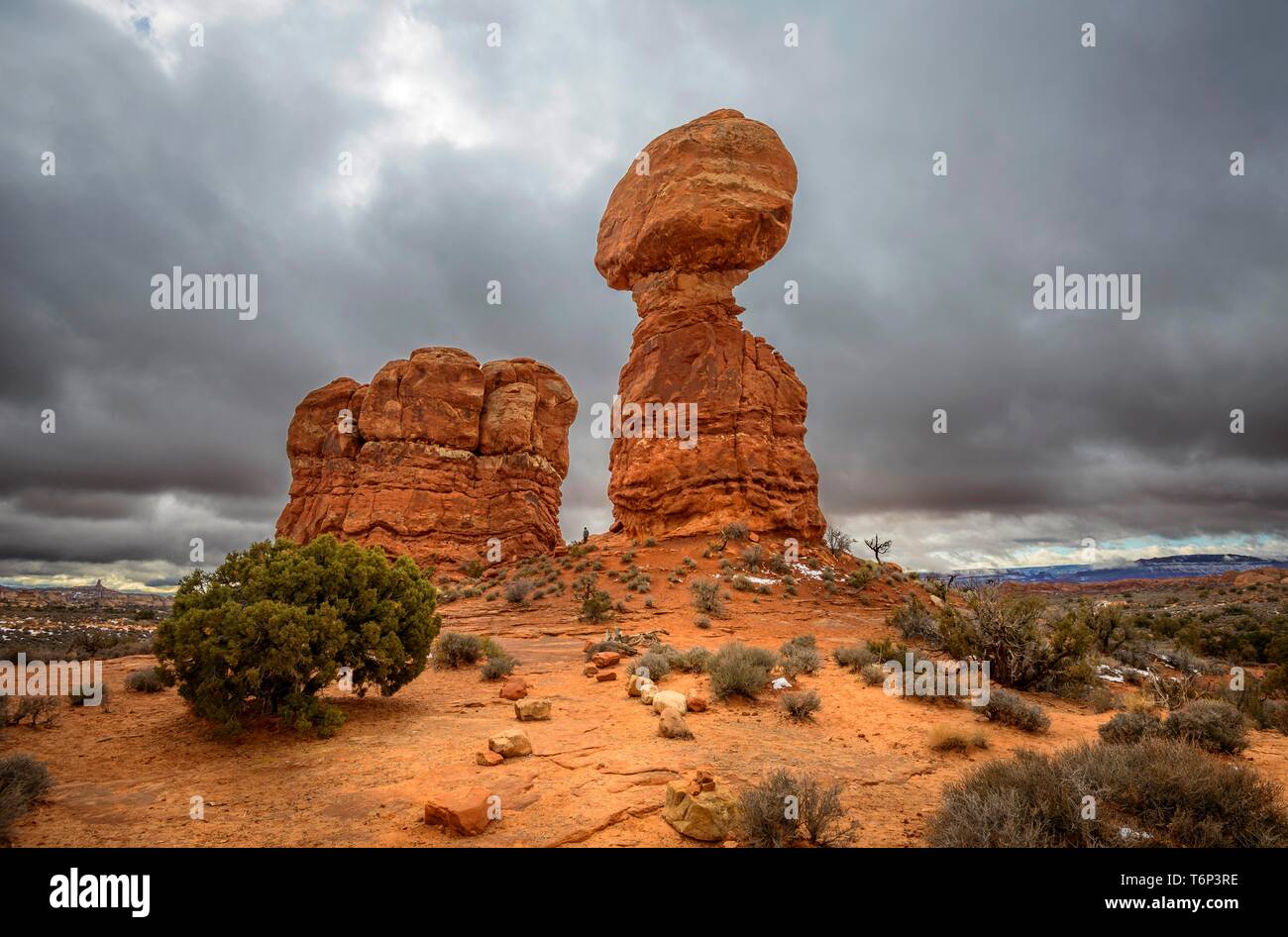 Rock formation Balanced Rock, dark cloudy sky, Arches National Park, near Moab, Utah, USA Stock Photo