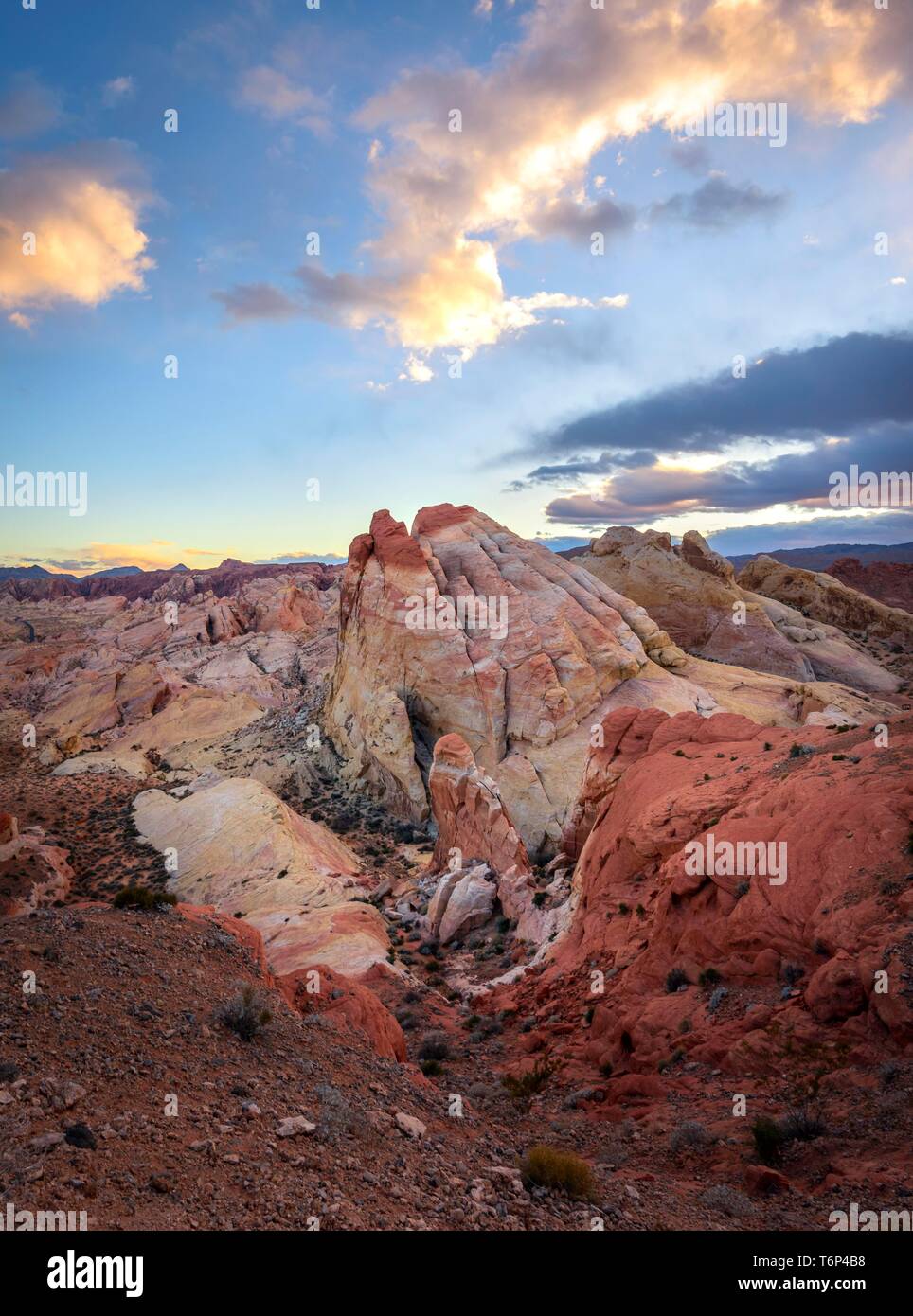 Colorful, red orange rock formations at sunset with colored clouds, White Dome, sandstone rocks, Valley of Fire State Park, Mojave Desert, Nevada, USA Stock Photo