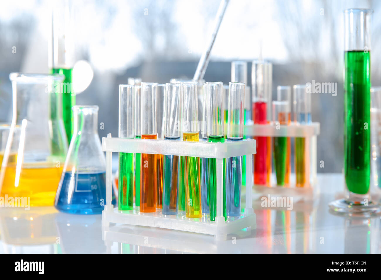 Chemical glassware with colorful samples on table Stock Photo Alamy