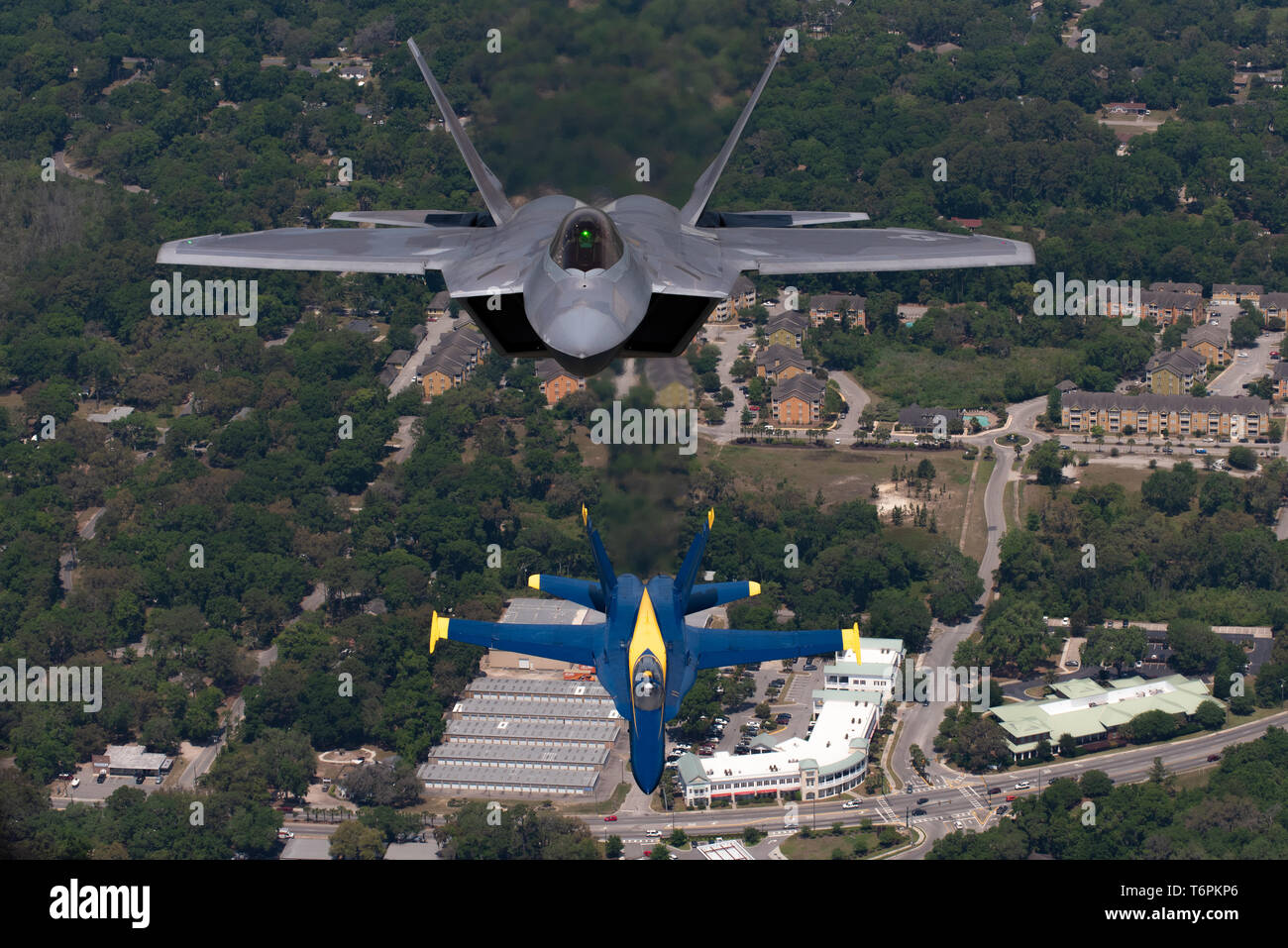 U.S. Air Force Maj. Paul 'Loco' Lopez, F-22 Demo Team commander/pilot, flies above the U.S. Navy Blue Angels during an iconic formation, in Beaufort, South Carolina, April 25, 2019. This hour-long historic flight featured two of the world's premier aerial demonstration teams. (U.S. Air Force photo by 2nd Lt. Samuel Eckholm) Stock Photo