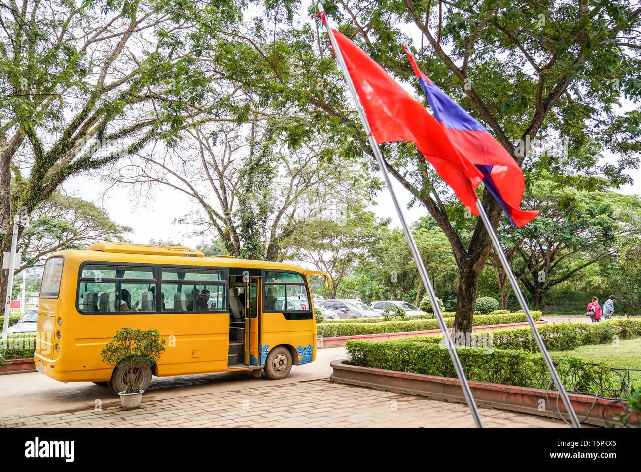 Ton Pheung district, Laos - 13 January 2018, Yellow Laos bus waiting for passengers at Golden triangle special economic zone. Stock Photo