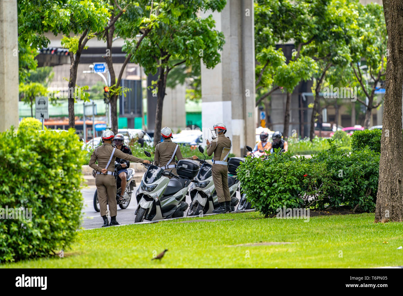 Bangkok, Thailand - 17 June 2018: Three Thailand traffic police / cop on duty at the road near the junction, Bangkok Thailand. Stock Photo