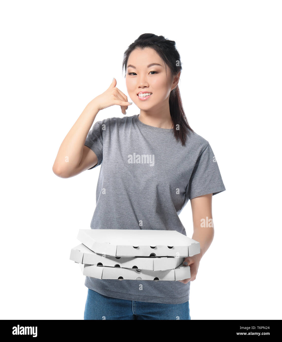 Asian woman with cardboard pizza boxes on white background. Food delivery service Stock Photo