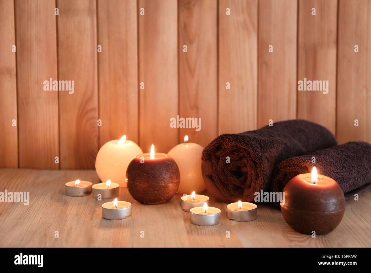 Beautiful burning candles with towels in sauna bath Stock Photo - Alamy