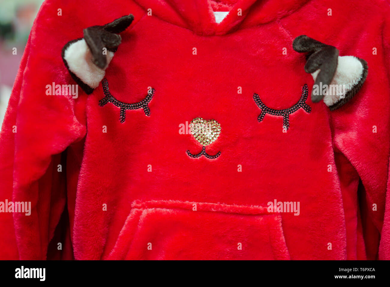 Red reindeer face on kids clothes. Stock Photo