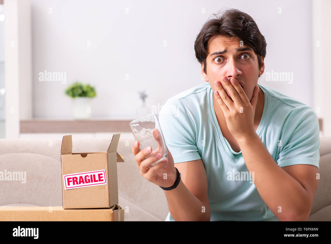 Man opening fragile parcel ordered from internet Stock Photo - Alamy