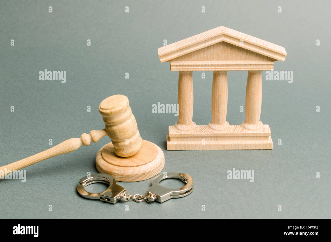 Courthouse and handcuffs. The concept of the court. Verdicts in criminal cases. Justice. The judicial system. Legal power. Criminal Code. Repression a Stock Photo