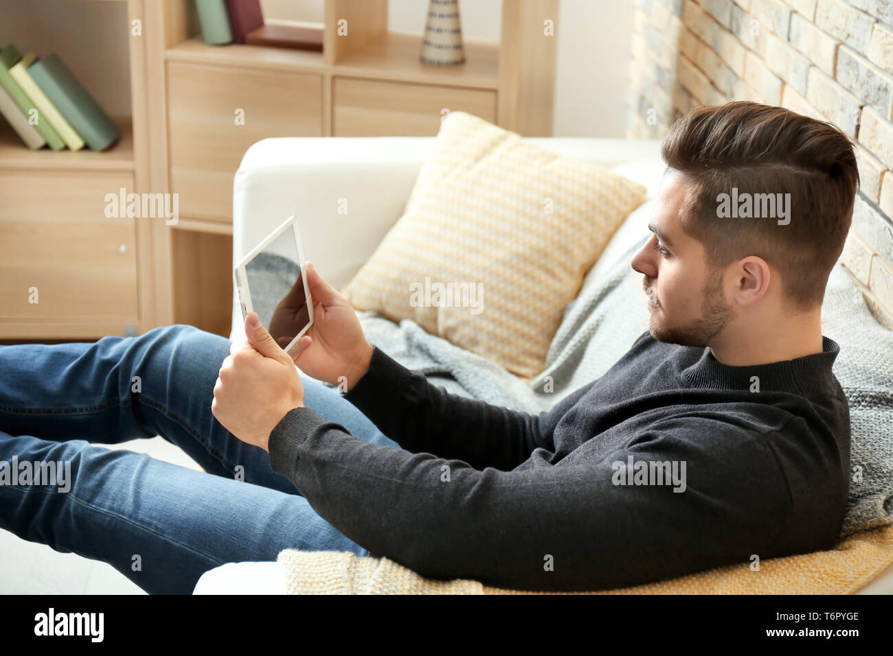 Young man using tablet at home Stock Photo