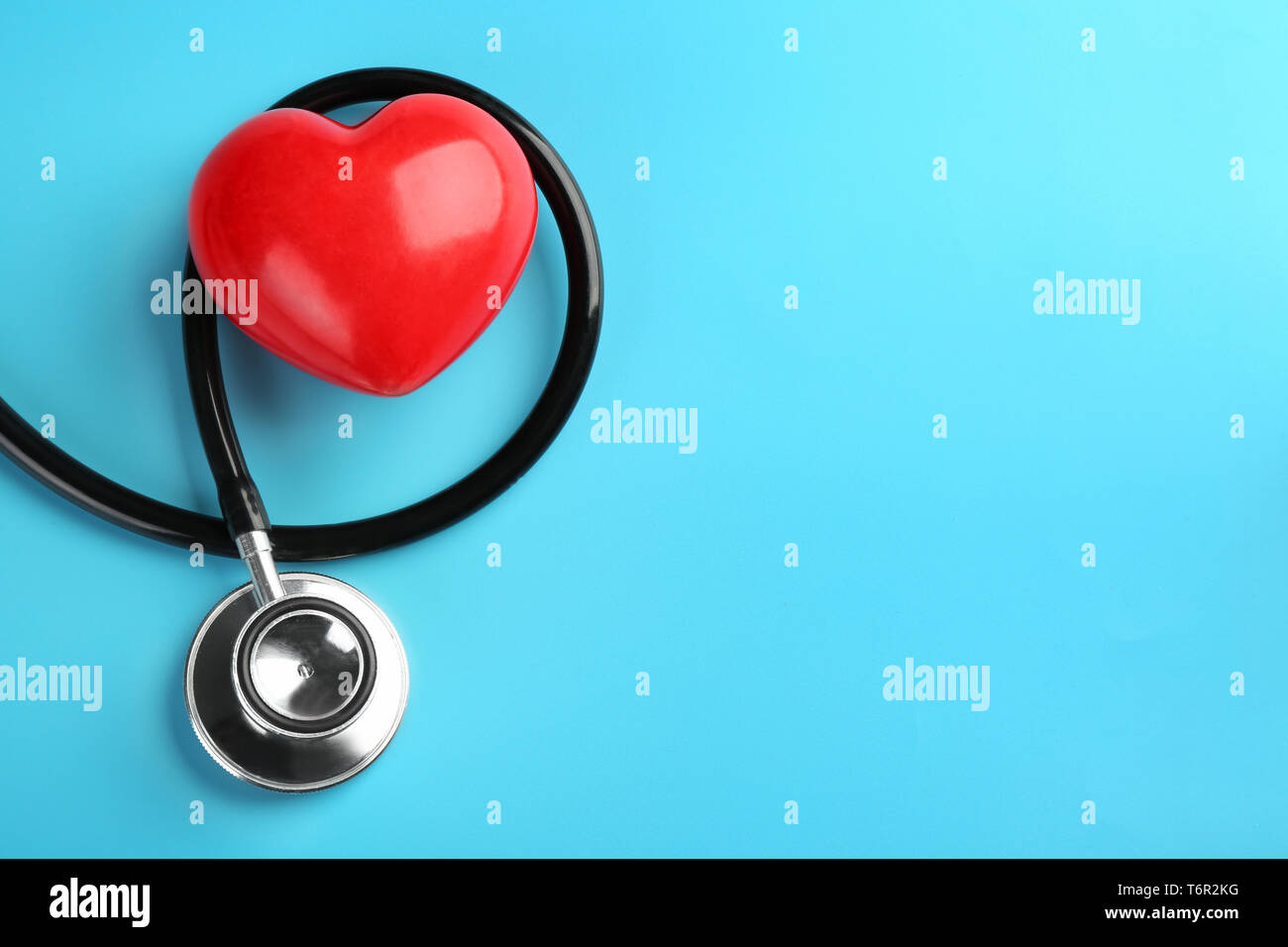 Stethoscope with small heart on color background Stock Photo - Alamy