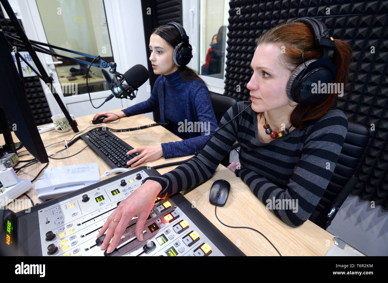 Sound engineer sitting in front of monitor at the radio studio. Kiev