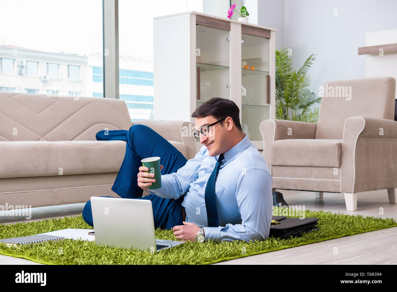 Businessman taking work home and working overtime Stock Photo