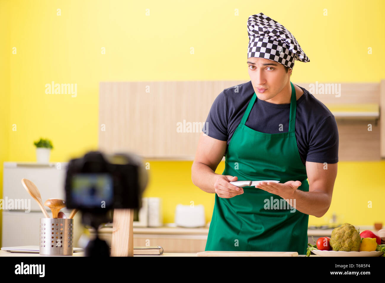 Young chef blogger explaining food preparation Stock Photo