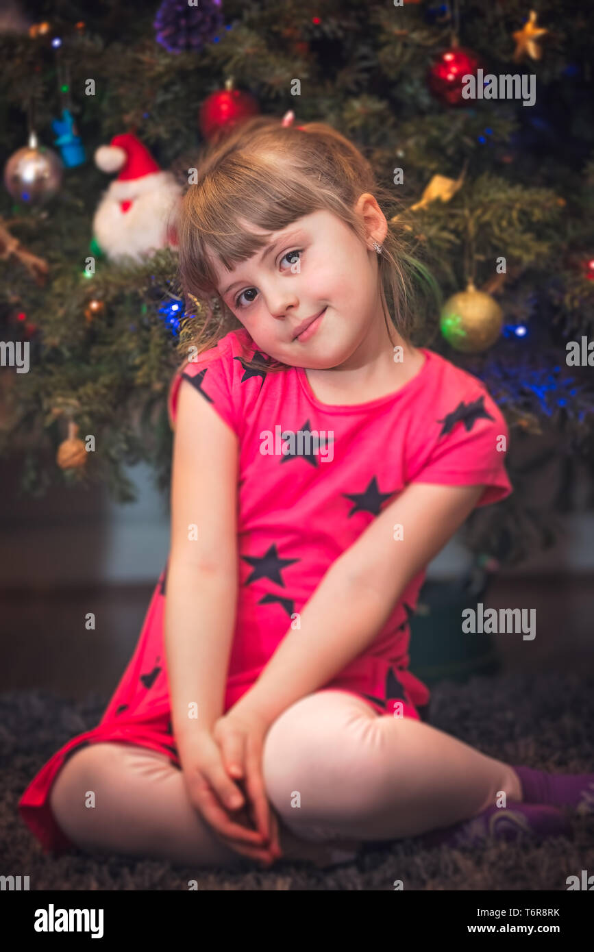 Portrait of a girl in front of Christmas tree Stock Photo