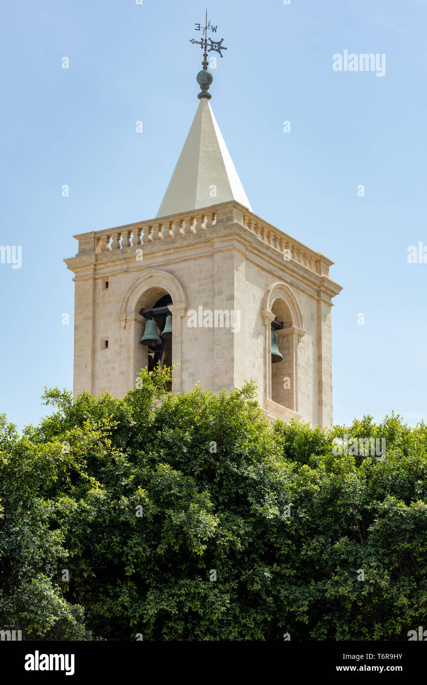 The weather vane and bells of one of the two mannerist styled bell towers of St John's Co-Cathedral in Valletta Stock Photo