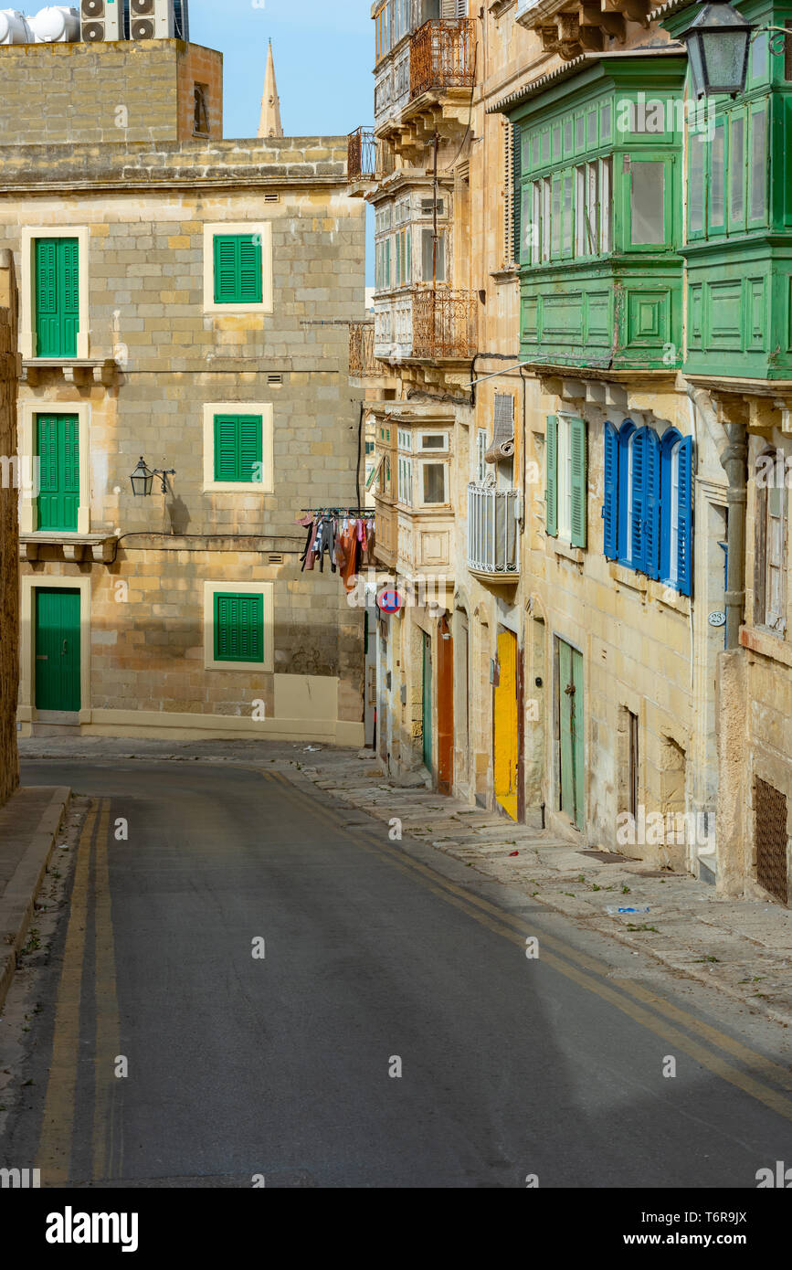 Traditional Maltese houses in San Andrija St, with their vibrant, enclosed timber balconies (galleriji) and colourful shutters and doors. Stock Photo
