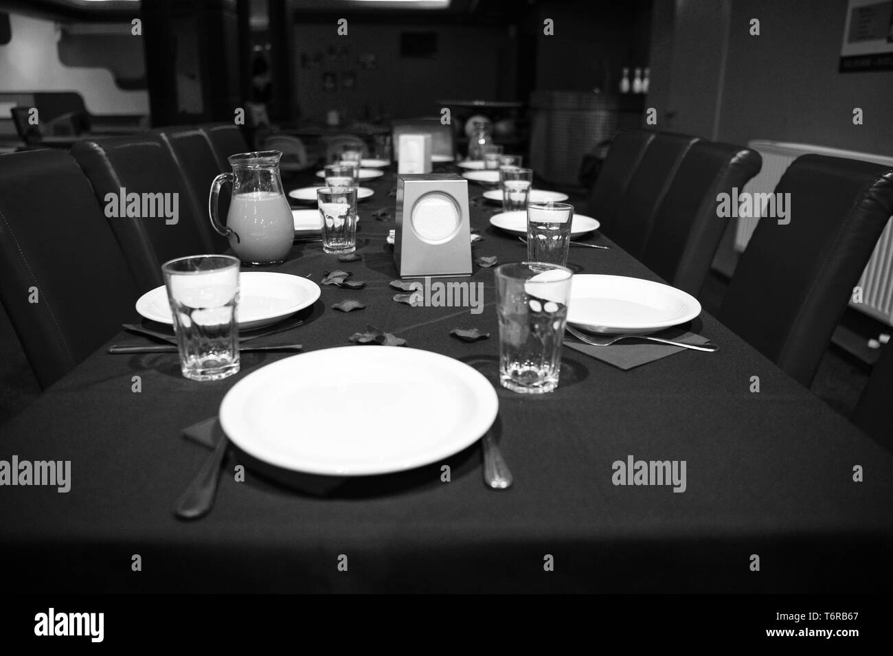 Restaurant table served with plates and glasses.Table prepared for
