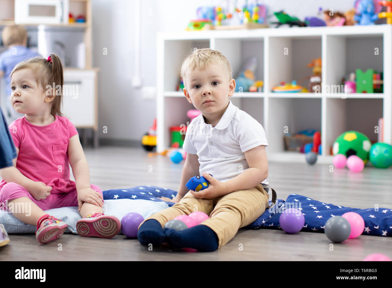 Group of babies toddlers playing in kindergarten Stock Photo