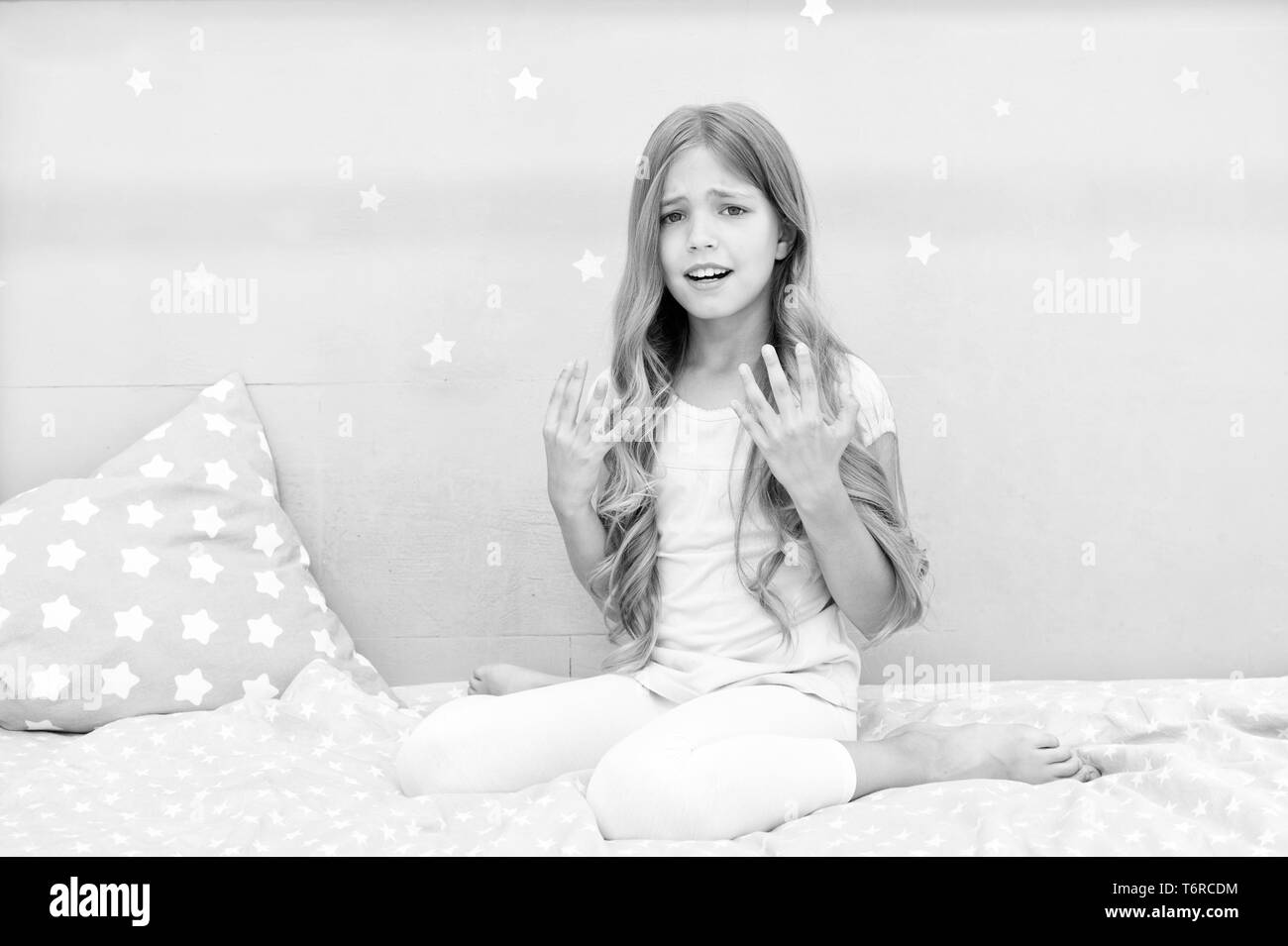 Girl disappointed with long curly hair grey background. Things you