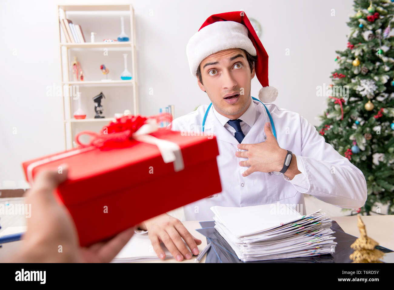 Doctor with gift box in the hospital Stock Photo - Alamy