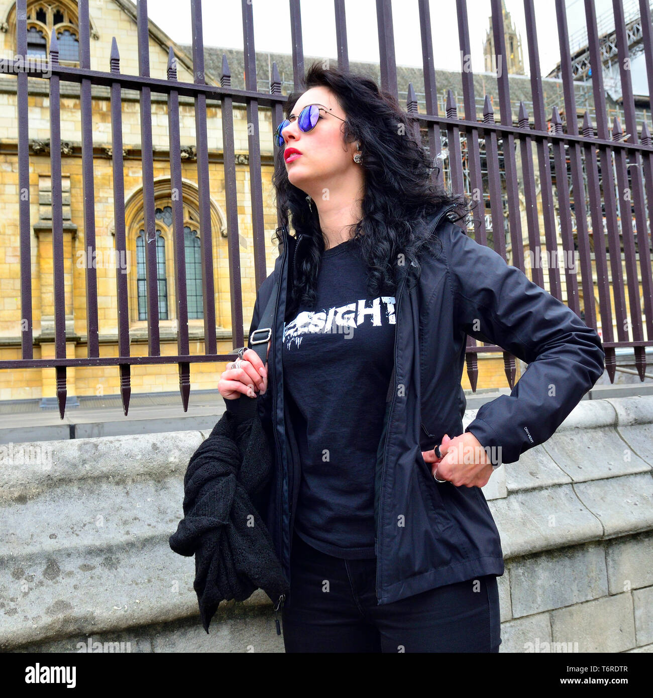 London, England, UK. Woman wearing reflcetive sunglasses by the Houses of Parliament, Westminster Stock Photo