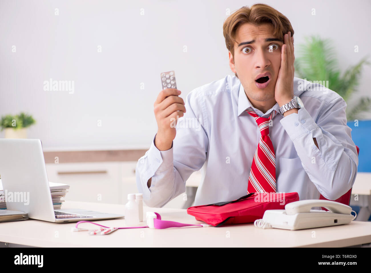 Man with first aid kit in the office Stock Photo Alamy