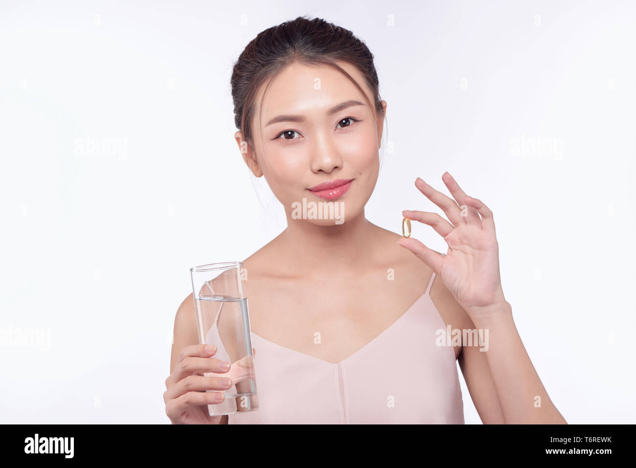 Woman sick, woman with pill and glass of water on isolated background Stock Photo