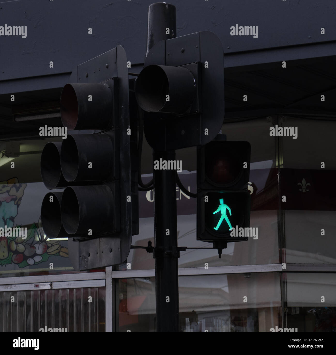 Pedestrian crossing light showing green walking man in Melbourne, Australia Stock Photo