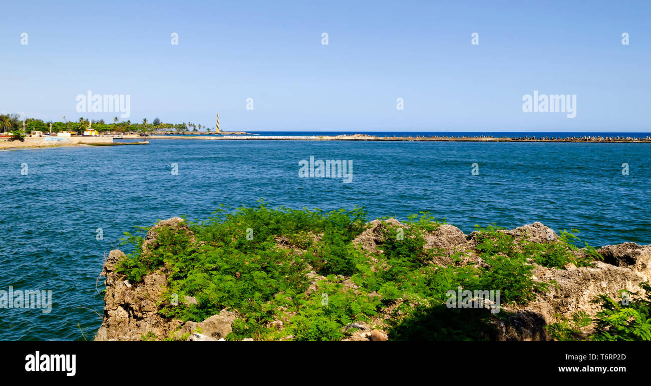 View of the port of Santo Domingo Dominican Republic from Juan Baron square, with beautiful sunny day and blue waters with boats arriving at port Stock Photo