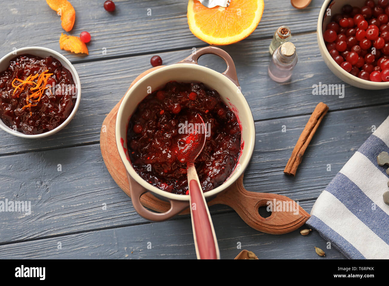 Flat lay composition with cranberry sauce and ingredients on wooden background Stock Photo