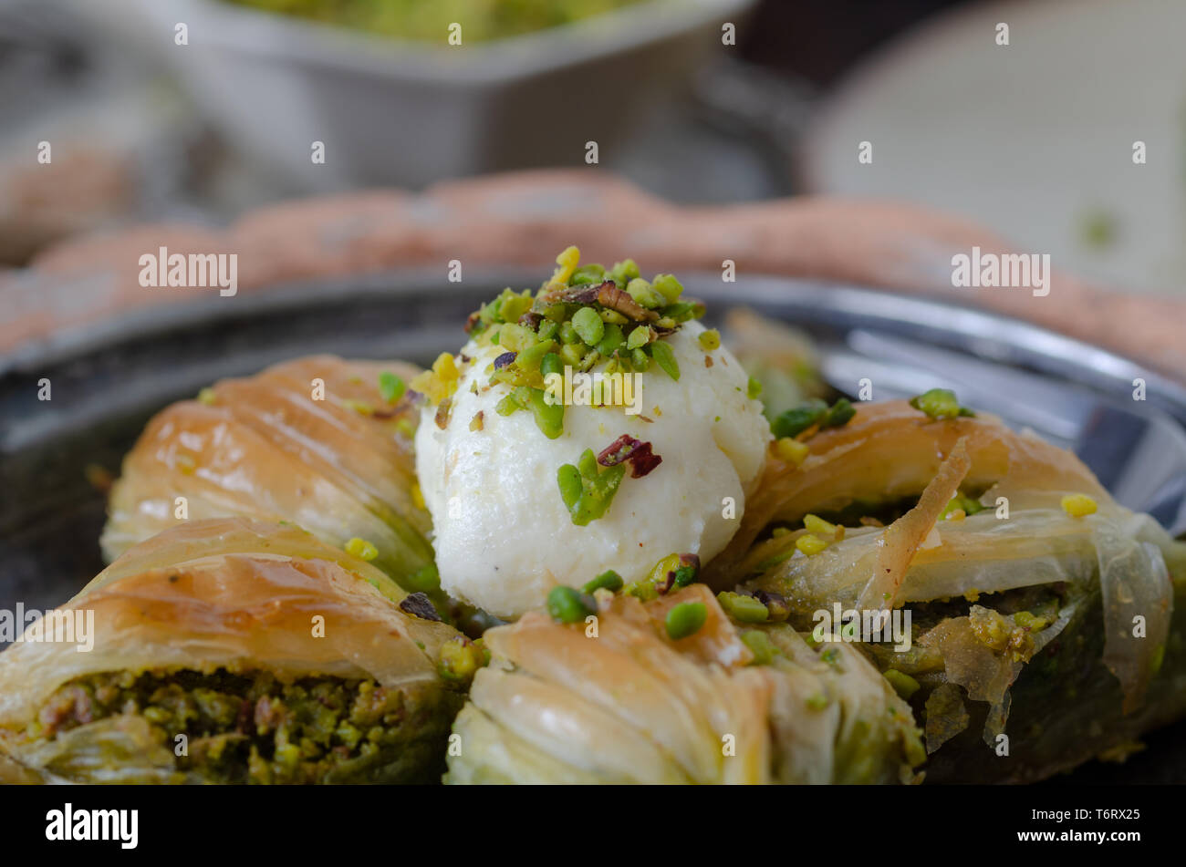 Mussel shaped special Turkish baklava with pistachio in the copper plate .Conceptual of Islamic Feasts. Stock Photo
