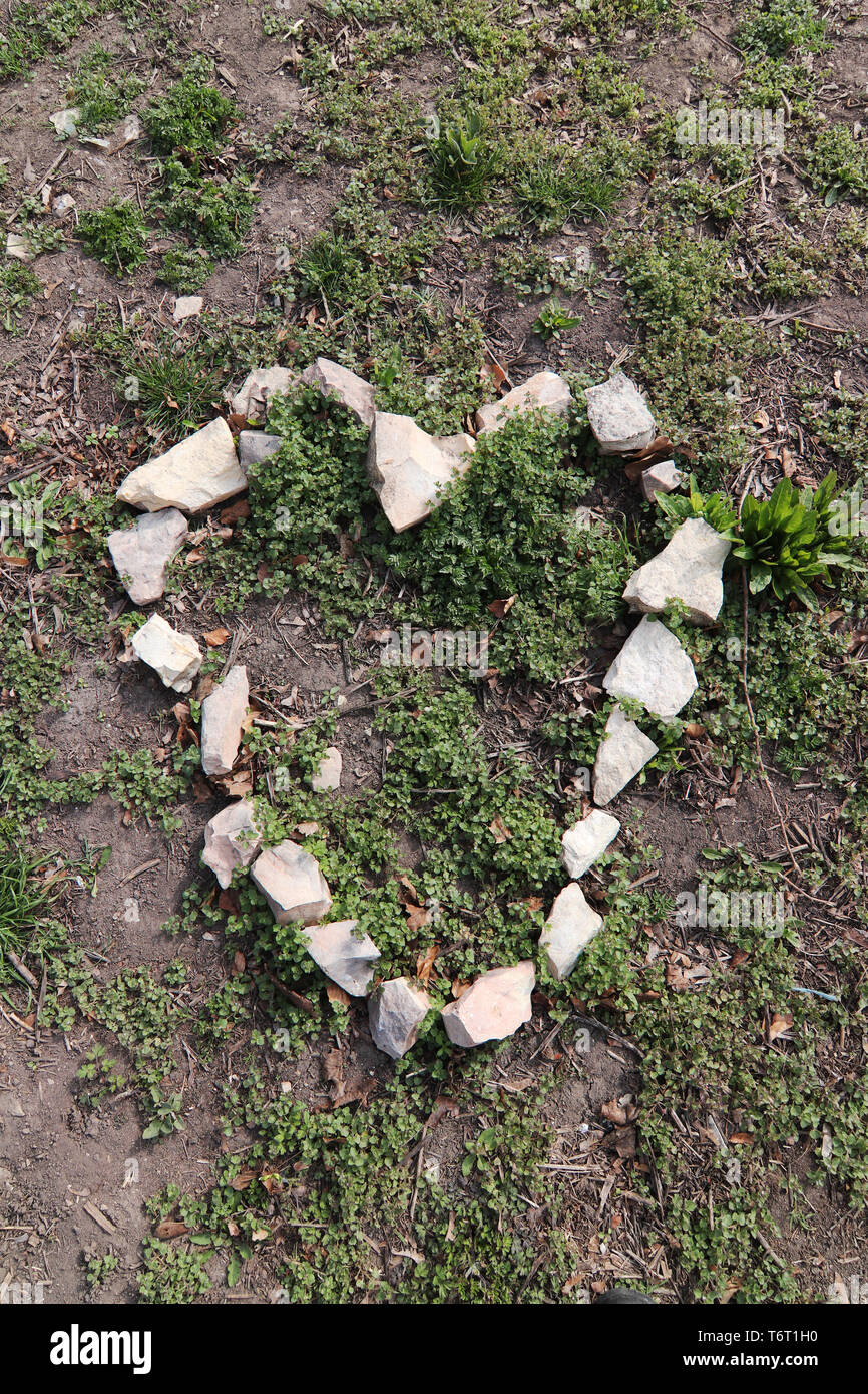 Heart shape from stones on the ground Stock Photo