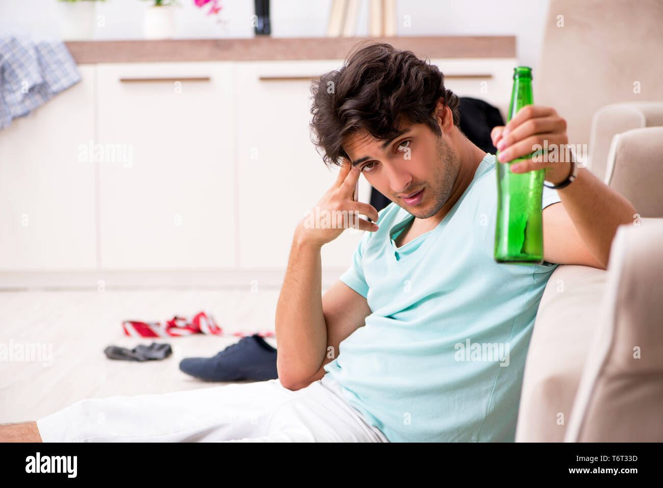 Young drunk handsome man after party at home Stock Photo - Alamy