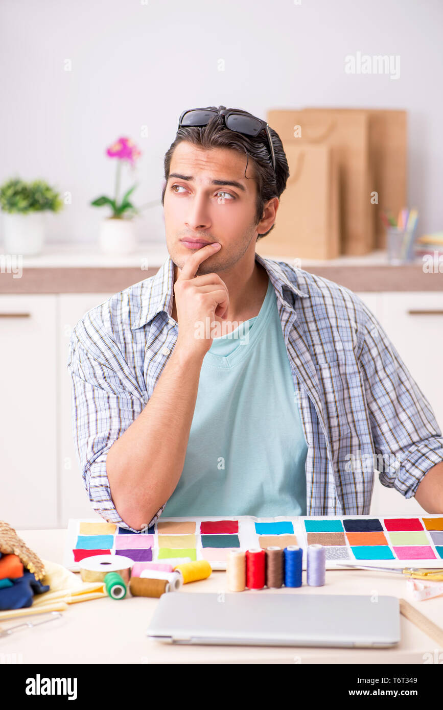 Young handsome tailor working in his workshop Stock Photo - Alamy
