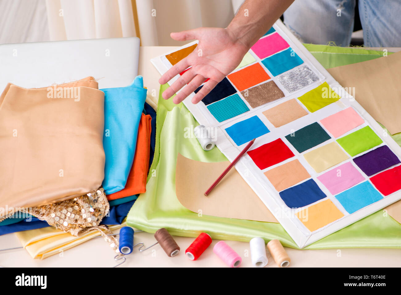 Young handsome tailor working in his workshop Stock Photo - Alamy