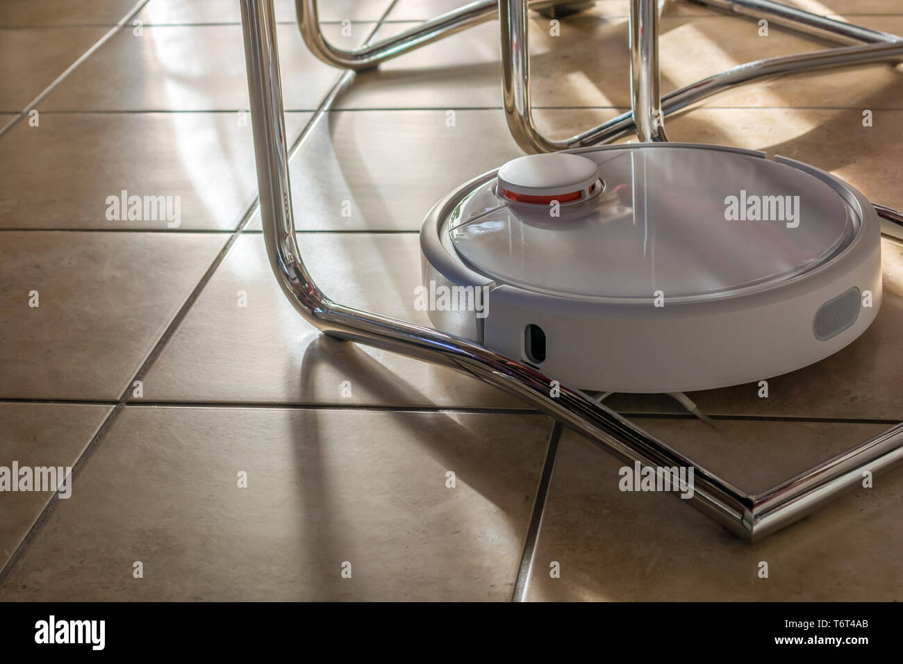 Modern robotic vacuum cleans in all corners Stock Photo Alamy