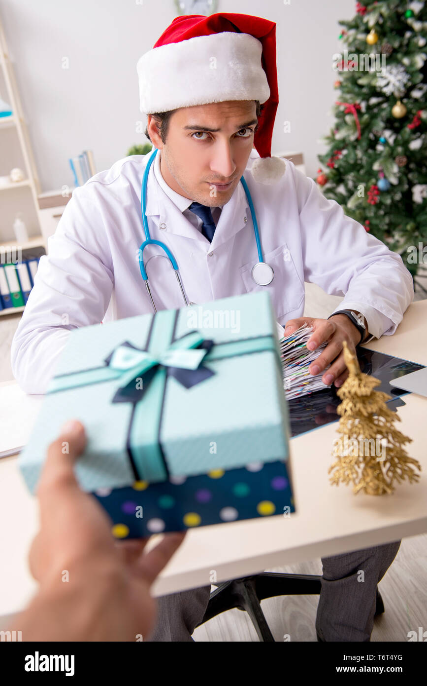 Doctor with gift box in the hospital Stock Photo - Alamy