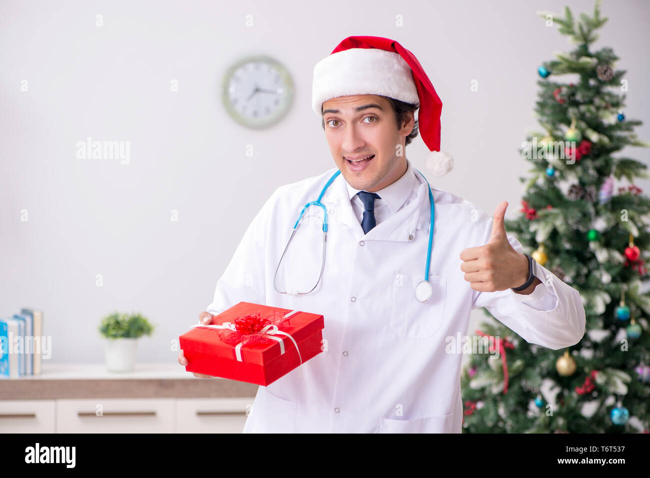 Doctor with gift box in the hospital Stock Photo - Alamy