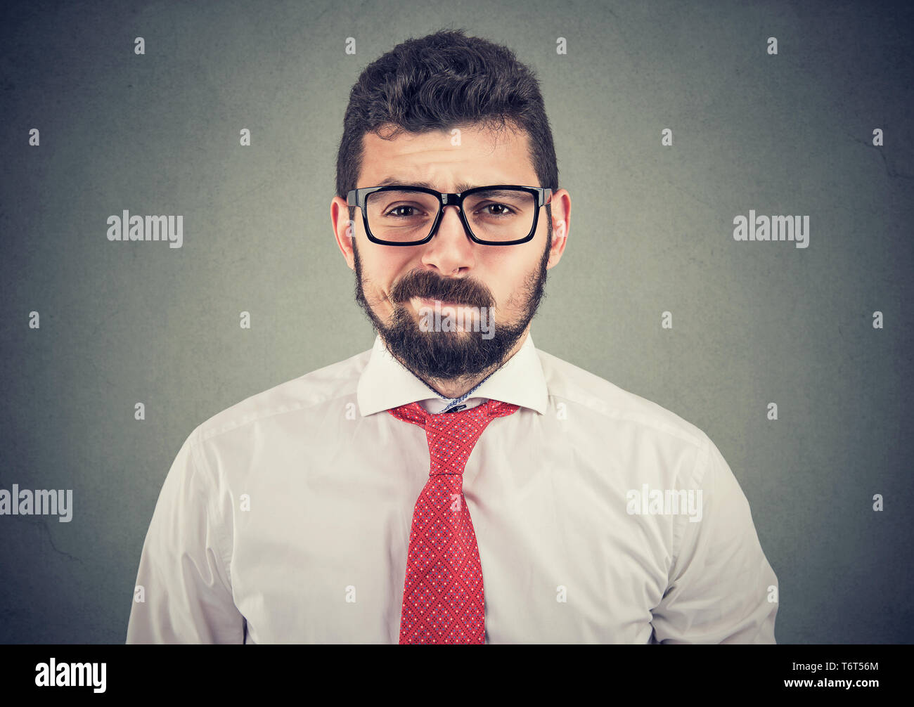 Skeptical doubtful businessman looking at camera Stock Photo